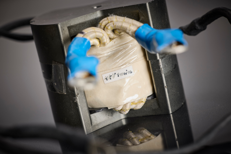 Le détail illustre le concept d'isolation à faibles décharges partielles du bobinage avec fil de litz HF et fixation mécanique supplémentaire, conçu pour des décennies de fonctionnement dans l'alimentation auxiliaire des véhicules ferroviaires.